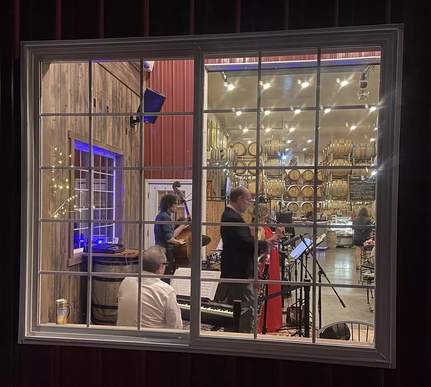 Looking through the window of our Winery with Jazz musicians performing