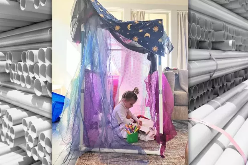 A child sits inside a homemade PVC pipe fort.