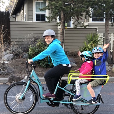 Mom with two kids on a bike- it’s me! Riding my cargo bike with my kids down our street in Bend. We live near the bf laming chicken round about so we bike around. I’ll be riding down to the farmer’s market today.
Photo credit-my husband, Steve.