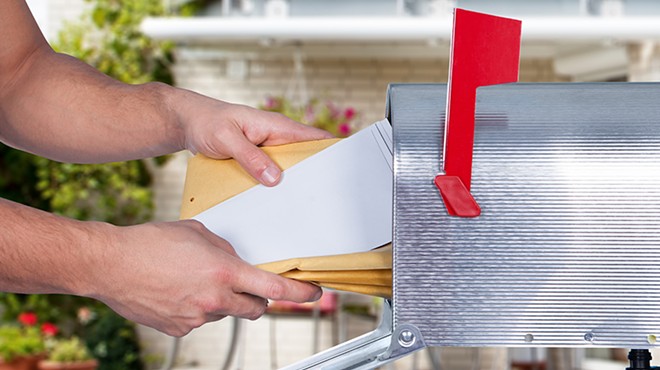 Person pulls mail from mailbox