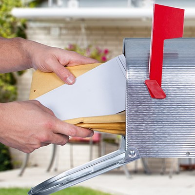 Person pulls mail from mailbox