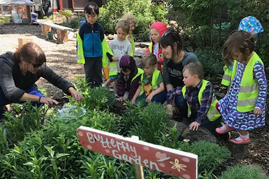 Children gather around a Butterfly Garden