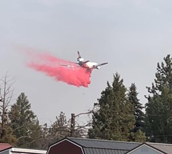 Plane dropping fire retardant on Mile 132 Fire