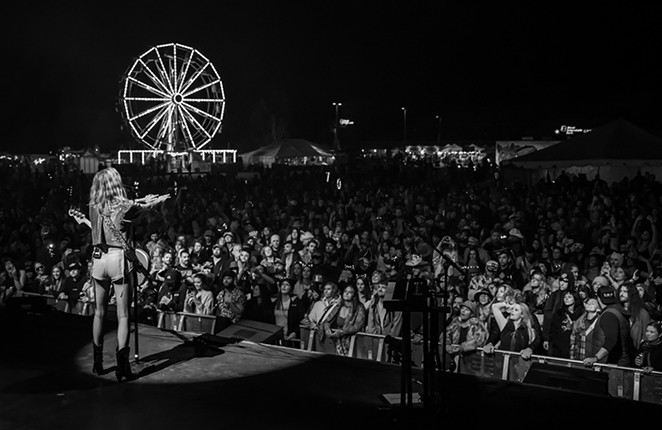 Stage at night with Ferris Wheel in background